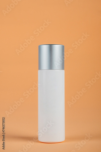 Cosmetic product in tube  bottle  lotion or serum seed on cream background. 