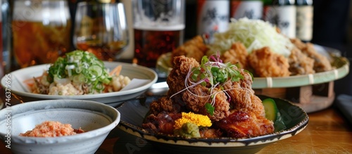 A wooden table is topped with various plates of food, including Zangi, the crispy Hokkaido style deep-fried chicken sensation. The dishes are neatly arranged and ready to be enjoyed.