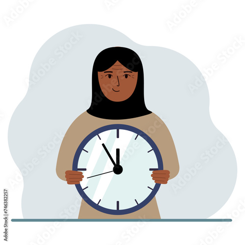 The woman is holding a big clock in his hands. Time management, planning, organization of working time, effective business, deadline.