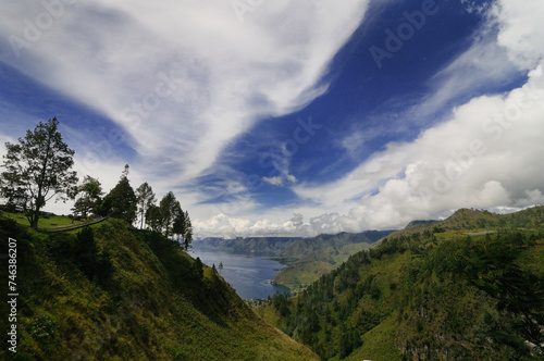 Scenic viw of lush green muntain hill and lakeside of Toba from Tongging Viewpoint in North Sumatra, Indonesia. photo