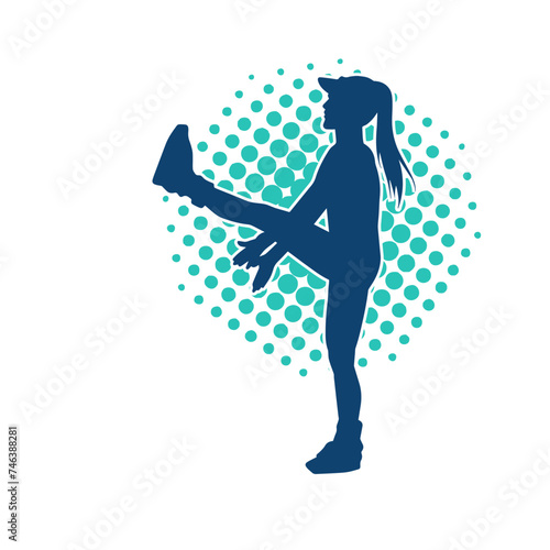 Silhouette of a slim sporty woman doing pilates exercise. Silhouette of a sporty female doing physical exercise. 