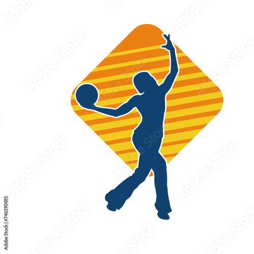 Silhouette of a slim sporty woman doing pilates exercise using gym ball. Silhouette of a sporty female doing physical exercise using fitness ball. 