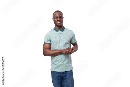 portrait of a young positive short-haired american man dressed in a mint summer t-shirt on a white background