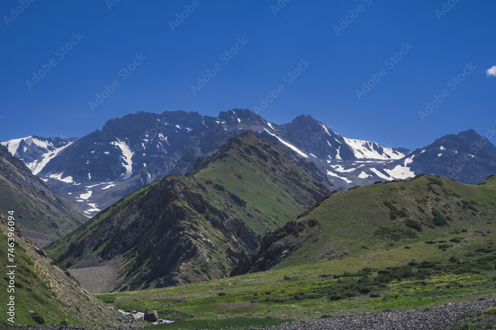 Tien Shan Mountains in the Koksai Gorge in the Aksu-Zhabagly Nature Reserve in Asia in Kazakhstan in summer under a blue sky
