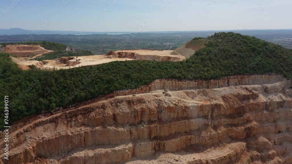 Marble quarry Italy. 4K video on Drone. Video panorama of an open pit in the mountains of Italy. Plot of marble quarry against the blue sky. Extraction of marble in a mountain quarry.
Marble quarry Italy. 4K video on Drone. Video panorama of an open pit in the mountains of Italy. Plot of marble quarry against the blue sky. Extraction of marble in a mountain quarry.