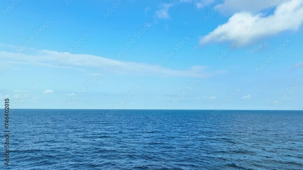 Aerial vista reveals the boundless expanse of azure sea, adorned by majestic waves, beneath a canvas of blue skies and fluffy clouds. Sea stock footage. Nature loop video background. 4K.
Aerial vista reveals the boundless expanse of azure sea, adorned by majestic waves, beneath a canvas of blue skies and fluffy clouds. Sea stock footage. Nature loop video background. 4K.