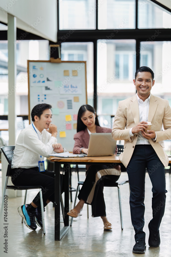 Portrait of a confident businessman standing in the boardroom during a meeting Portrait of a confident businessman standing in the boardroom during a meeting