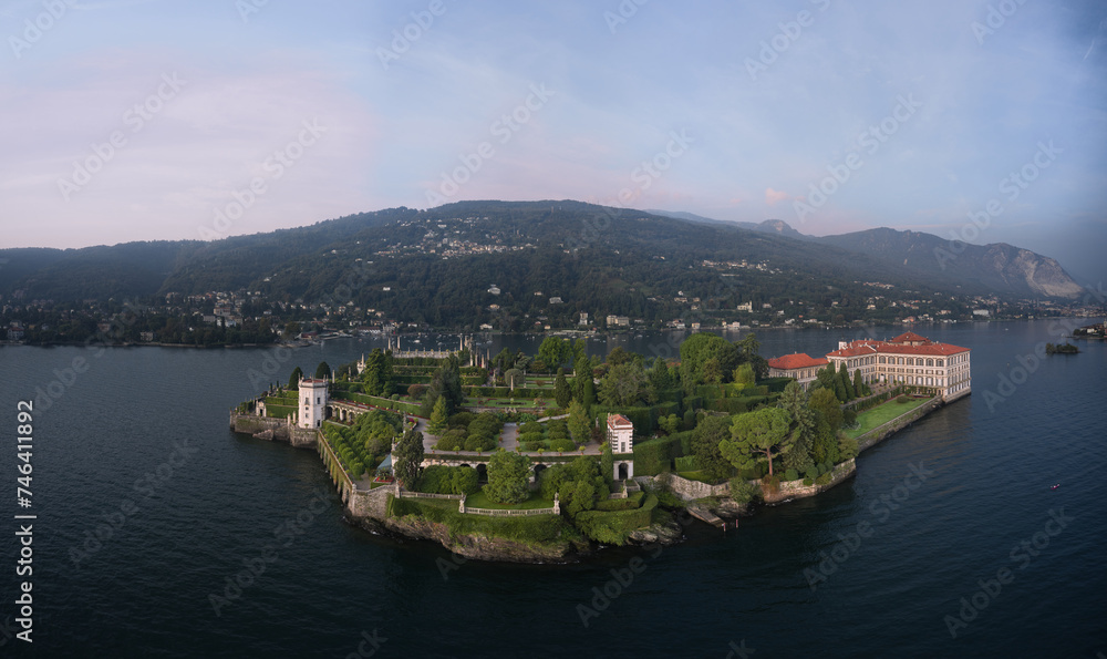 Panorama at sunrise on Lake Maggiore aerial view. Isola Bella and Stresa town aerial panoramic view. Lake Maggiore, island, Isola Bella, Italy.