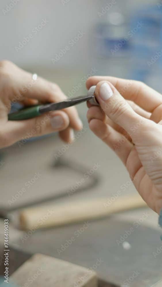 Female Artisan Makes Jewelry By Hand Using Pliers. Selective Focus Female Artisan Makes Jewelry By Hand Using Pliers. Selective Focus