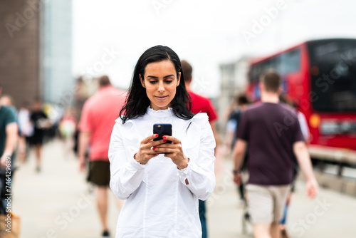 Business woman using a smartphone in the city