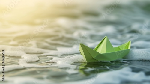 green paper boat on the water.