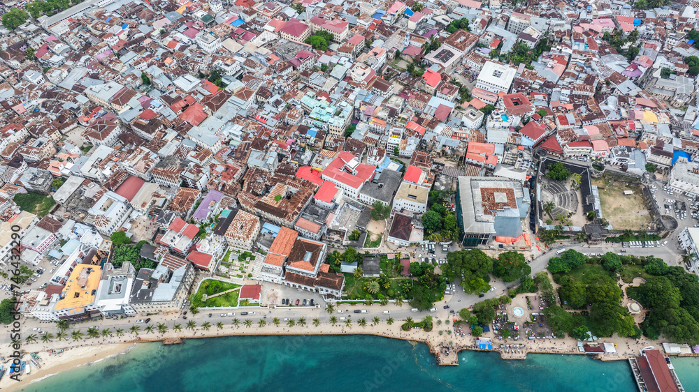 Aerial city view of area around the historic Stone Town, the oldest part of Zanzibar Town on Unjuja island, Tanzania with historic buildings and beach promenade 