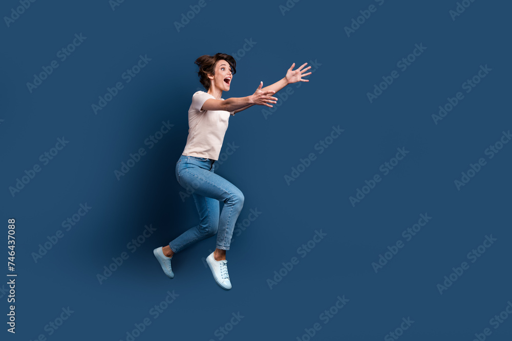 Full size photo of attractive young woman run stretch hands want hug dressed stylish white clothes isolated on dark blue color background