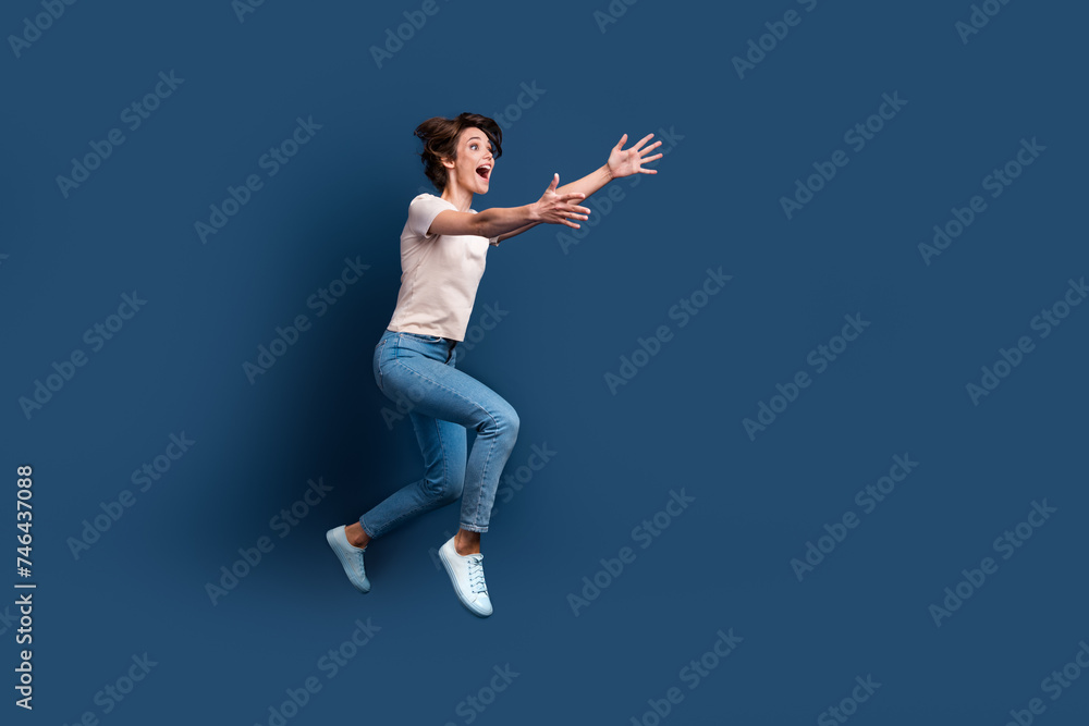 Full size photo of attractive young woman run stretch hands want hug dressed stylish white clothes isolated on dark blue color background Full size photo of attractive young woman run stretch hands want hug dressed stylish white clothes isolated on dark blue color background