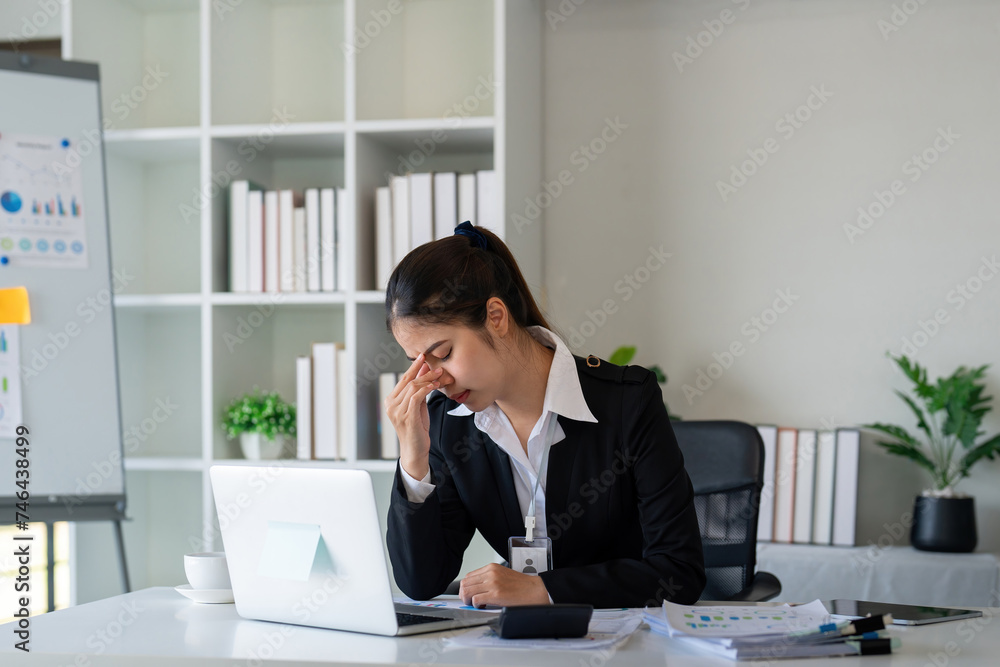 Business woman stress and headache report and planning, research. anxiety or tired on laptop computer Business woman stress and headache report and planning, research. anxiety or tired on laptop computer