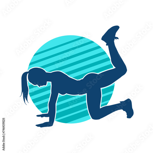 Fototapeta Naklejka Na Ścianę i Meble -  Silhouette of a slim sporty woman doing pilates exercise. Silhouette of a sporty female doing physical exercise. 