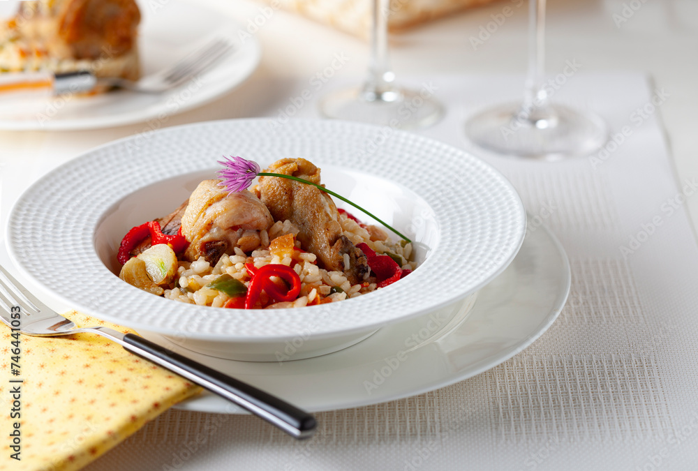 Naklejka premium Rice dish with chicken and seasonal vegetables