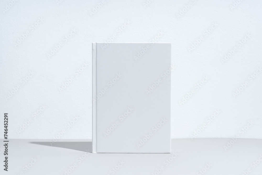 White notepad with hard cover on gray background White notepad with hard cover on gray background