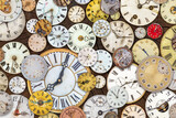 Collection of vintage weathered clocks and watches on a wooden background