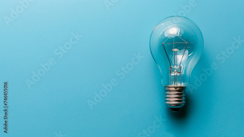 Close up of light bulb on blue background. Copy space.