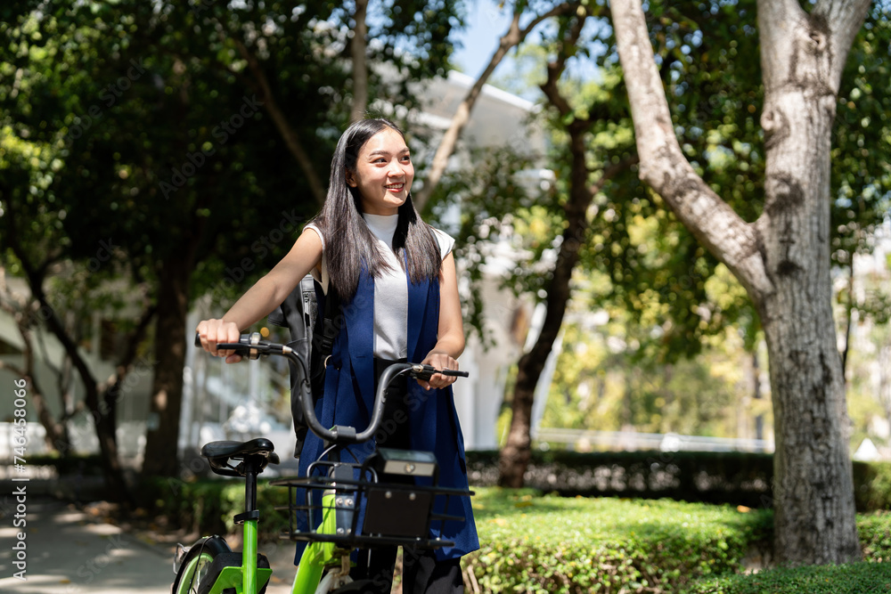 Obraz premium Eco friendly, Happy lifestyle asian beautiful young businesswoman riding bicycle go to office work at city street with bicycle in morning