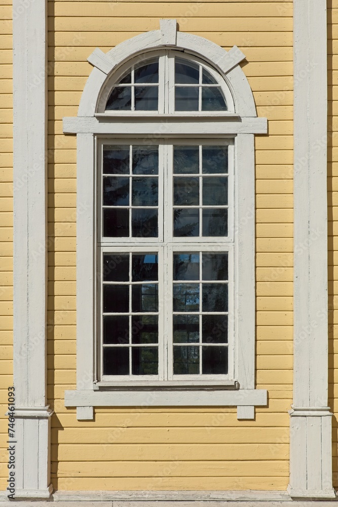 Window on a yellow painted building.