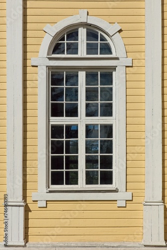 Window on a yellow painted building. © Raimo