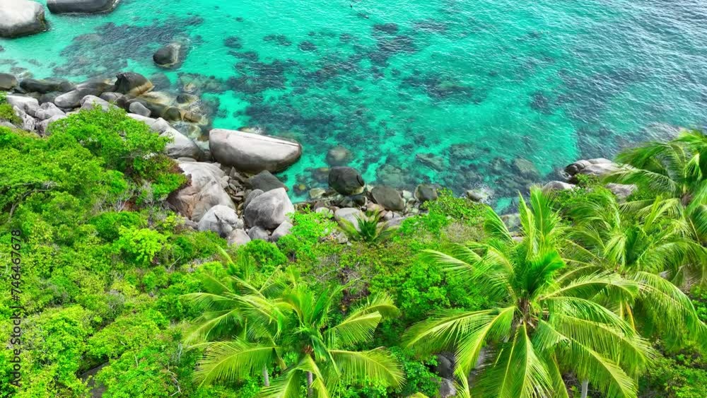 Capture the rugged beauty of a rocky coastline embraced by lush forests, coconut palms, and crystal-clear turquoise waters from above. Aerial drone. Ko Tao, Surat Thani Province, Southern Thailand.
Capture the rugged beauty of a rocky coastline embraced by lush forests, coconut palms, and crystal-clear turquoise waters from above. Aerial drone. Ko Tao, Surat Thani Province, Southern Thailand.