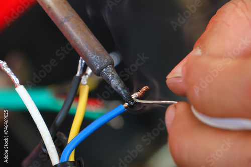 selective focus wires in the hand of a car mechanic Practicing repairs to the ATV's electrical system. Wires of various colors help you know the direction of your car's electrical system.