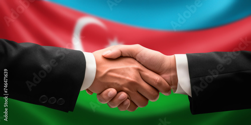 Businessman, diplomat in suits clasp hands for handshake over Azerbaijan flag, agree on united success in trade, diplomacy, cooperation, negotiation, teamwork in commerce, gesture of greeting