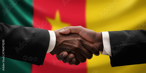 Businessman, diplomat in suits clasp hands for handshake over Cameroon flag, agree on united success in trade, diplomacy, cooperation, negotiation, support, teamwork in commerce, gesture of greeting