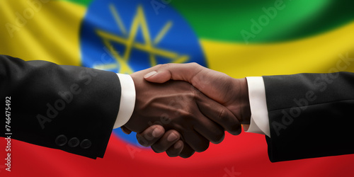 Businessman, diplomat in suits clasp hands for handshake over Ethiopia flag, agree on united success in trade, diplomacy, cooperation, negotiation, support, teamwork in commerce, gesture of greeting