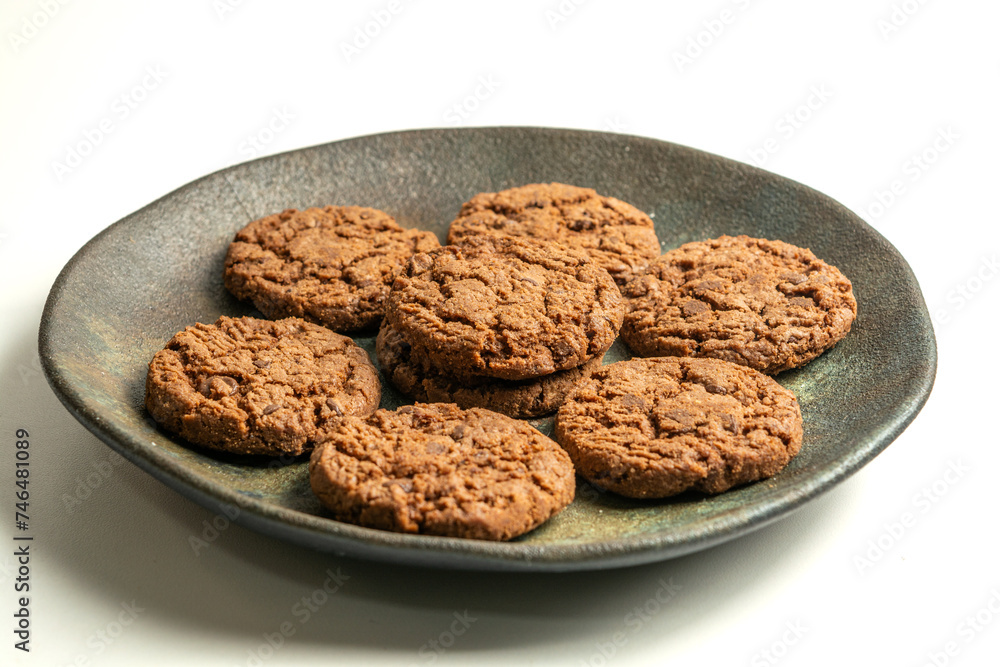 chocolate cookies on a dish isolated on a white background chocolate cookies on a dish isolated on a white background