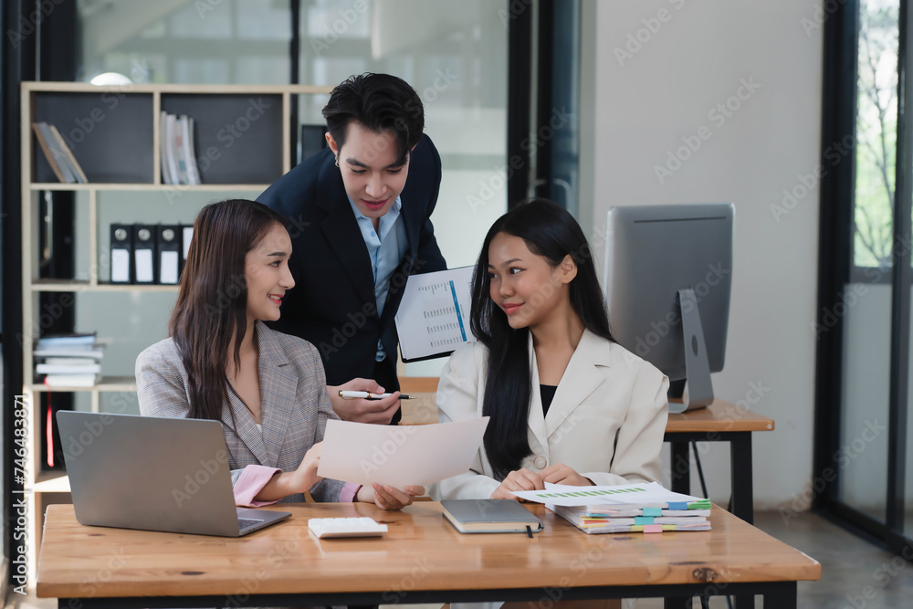 Professional team of Asian businesspeople collaborating on a new project in an office room. Professional team of Asian businesspeople collaborating on a new project in an office room.