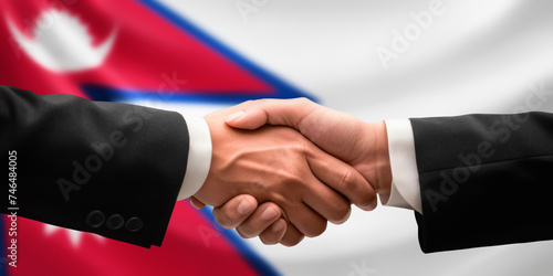 Businessman and diplomat in suits clasp hands for handshake over Nepal flag, agree on united success in trade, diplomacy, cooperation, negotiation, support, teamwork in commerce, gesture of greeting