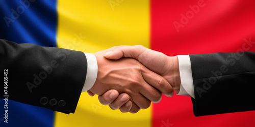 Businessman, diplomat in suits clasp hands for handshake over Romania flag, agree on united success in trade, diplomacy, cooperation, negotiation, support, teamwork in commerce, gesture of greeting
