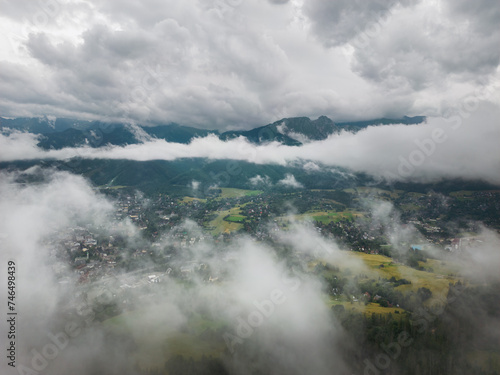 Aerial drone photo through the clouds in Zakopane, a resort town in southern Poland at the foot of the Tatra Mountains.