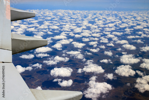 airplane flying over altocumulus clouds © Cenas brasileiras