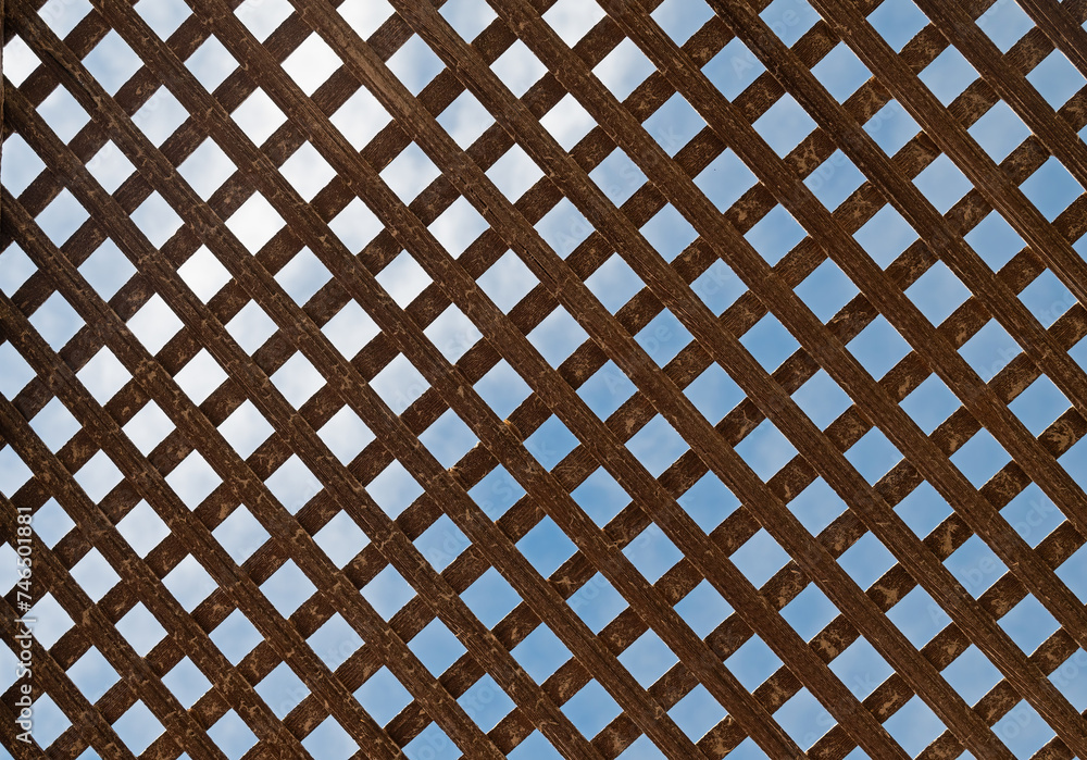 Texture of old wooden gate in metal frame. Background Texture of old wooden gate in metal frame. Background