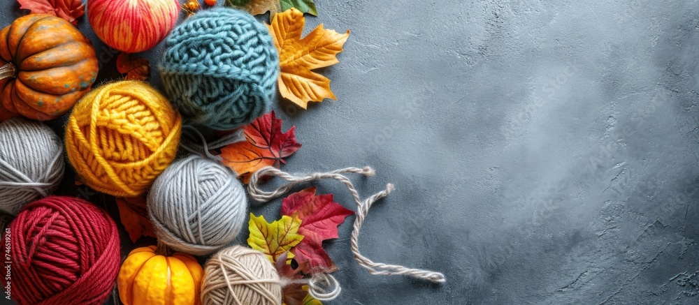 Knitting and crocheting supplies for autumn hobbies, displayed on a concrete background.