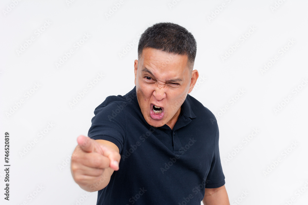 An intense middle aged Asian man pointing angrily at an unseen person, showing a strong emotional outburst. An intense middle aged Asian man pointing angrily at an unseen person, showing a strong emotional outburst.