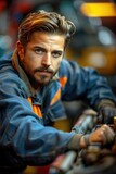 With a calm demeanor, the mechanic efficiently carries out repairs on a customer's vehicle, demonstrating his confidence in his skills as he tackles each task with precision and expertise
