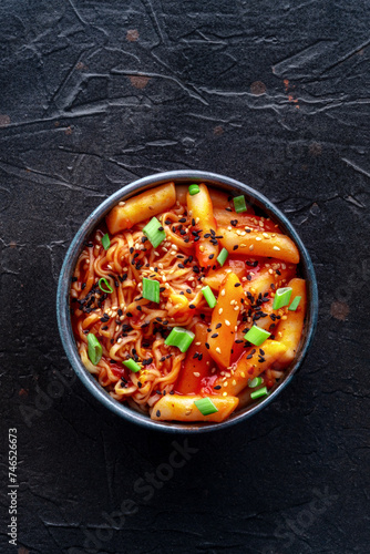 Rabokki, tteokbokki or topokki with ramen, Korean street food, spicy rice cakes in red pepper gochujang sauce, overhead flat lay shot