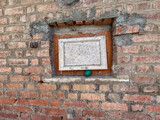 Small, sealed window on a weathered brick wall