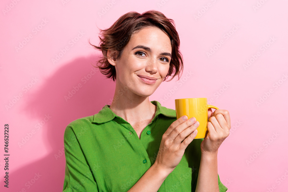 Photo portrait of lovely young lady hold coffee mug dressed stylish green garment isolated on pink color background Photo portrait of lovely young lady hold coffee mug dressed stylish green garment isolated on pink color background