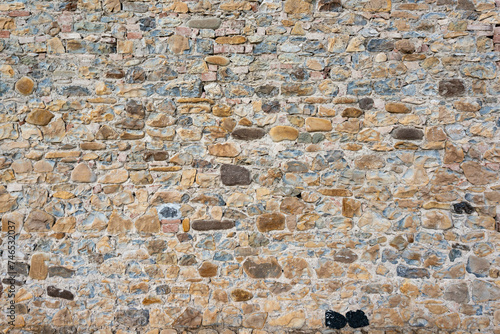Stone wall background and ancient tuff, Tuscany in Italy