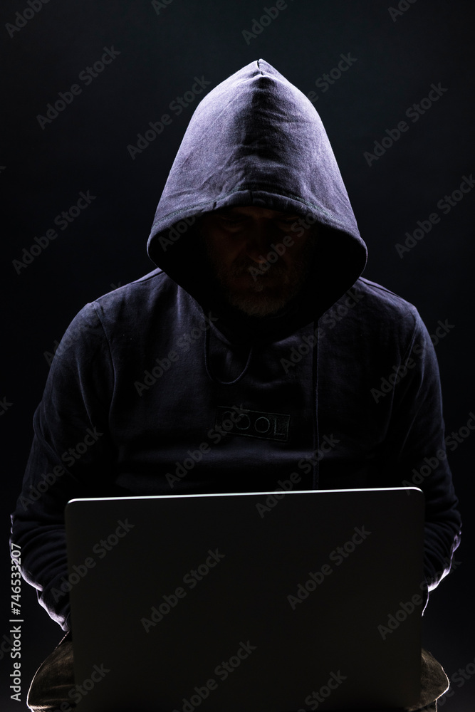 a shady figure that could represent a criminal, a hacker, ambiguity and duplicity