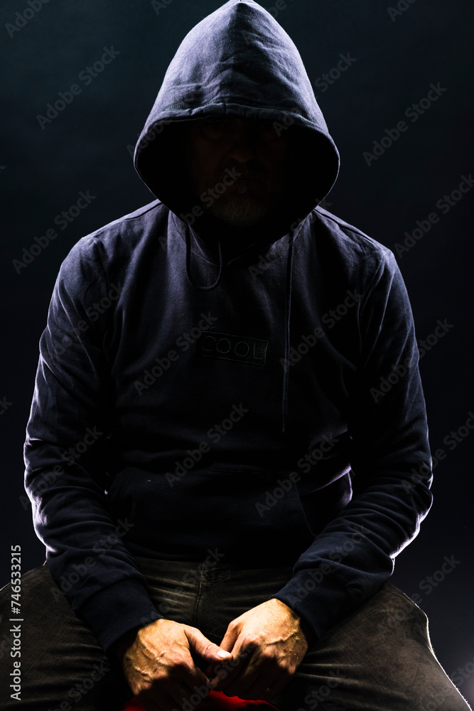 a shady figure that could represent a criminal, a hacker, ambiguity and duplicity