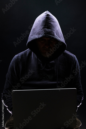 Obraz na płótnie a shady figure that could represent a criminal, a hacker, ambiguity and duplicity w salonie