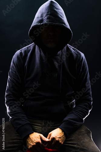 Obraz na płótnie a shady figure that could represent a criminal, a hacker, ambiguity and duplicity w salonie